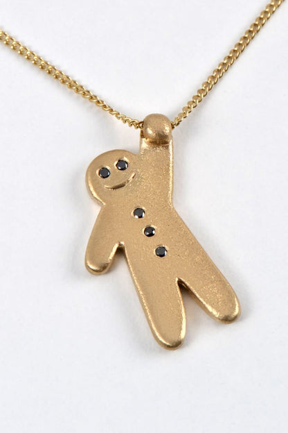 cute smiling gold gingerbread man necklace with black diamonds from British jewellery designer Christine Sadler