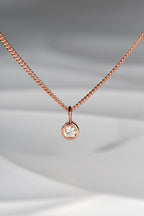 Handmade 9ct rose gold petite diamond necklace. The pendant measures 5mm in diameter and the diamond measures 3mm in diameter. The necklace is designed by british jewellery designer Christine Sadler and made in her workshop in Ayr