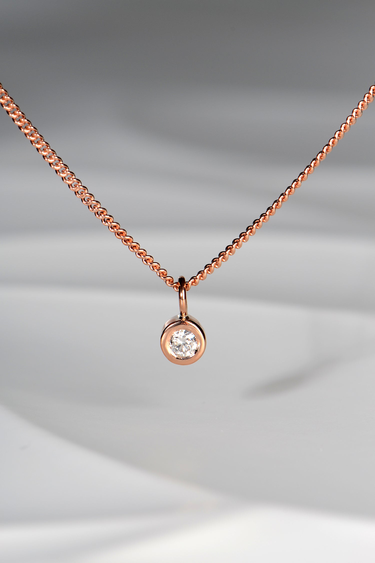 Handmade 9ct rose gold petite diamond necklace. The pendant measures 5mm in diameter and the diamond measures 3mm in diameter. The necklace is designed by british jewellery designer Christine Sadler and made in her workshop in Ayr