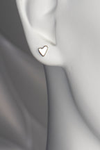 handmade heart earring on a white mannequin, showing elegant modern design and the size when worn