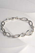 Sculptural DNA double helix link in sterling silver link bracelet — central feature of Christine Sadler’s Designer Genes's bracelet design