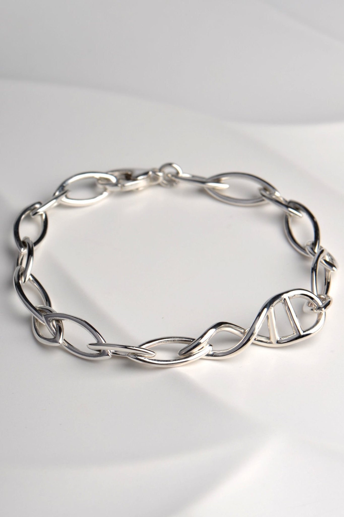 Sculptural DNA double helix link in sterling silver link bracelet — central feature of Christine Sadler’s Designer Genes's bracelet design