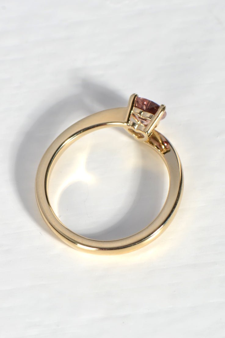 top view of modern gold ring that has a 0.60ct pink sapphire in a heart cut shape - Christine Sadler