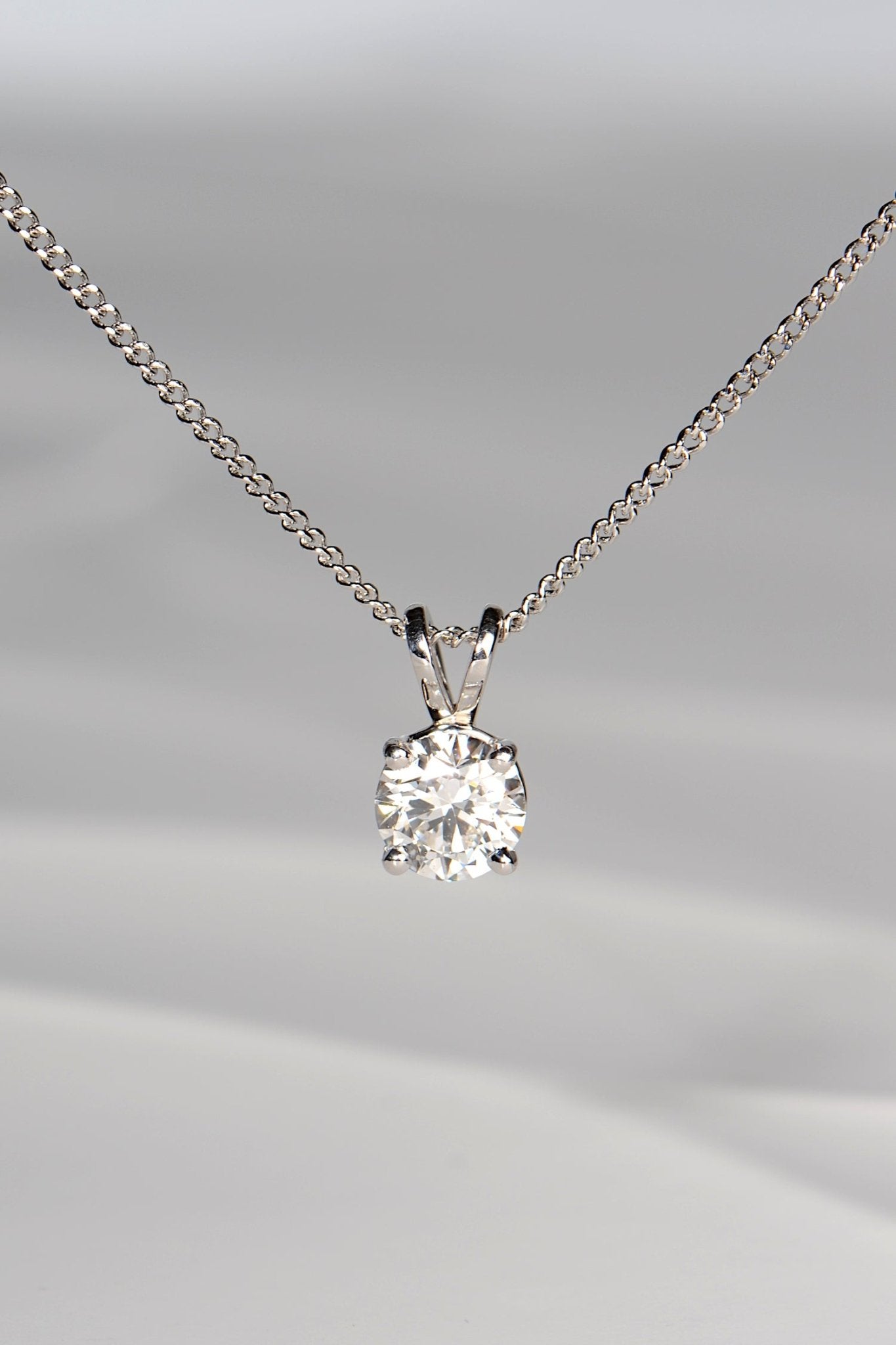 one carat platinum Lab Diamond necklace with a four claw setting and a V shaped pendant loop
