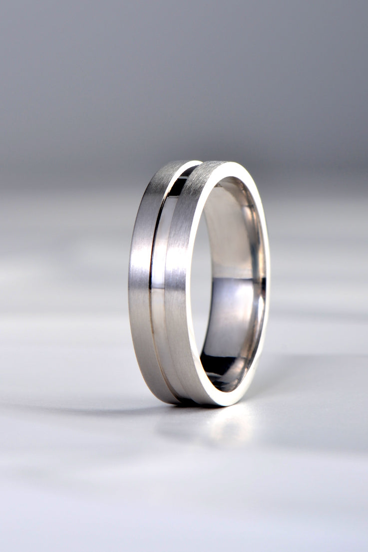 modern platinum gents wedding ring with a brushed finished and a highly polished centre