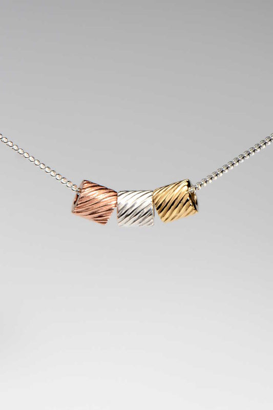 silver, yellow gold and rose gold pendants on a silver chain, a modern handmade design from British jewellery designer Christine Sadler's Bella Figura collection which is inspired by pasta