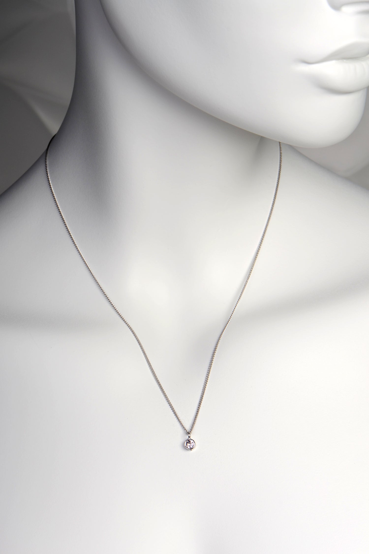 Handmade white gold morganite round pendant in 45cm hanging from a 45cm chain that sits about an inch below the collar bone