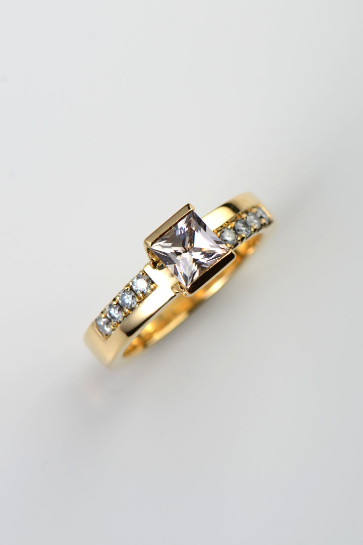 morganite and diamond 18ct yellow gold ring. This ring has diamonds set in the band below the morganite in an asymmetric design.