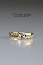18ct yellow gemstone ring set with a square morganite in a very contemporary setting with 8 round brilliant cut diamonds set into the band, 4 on each side of the morganite in an asymmetric pattern.