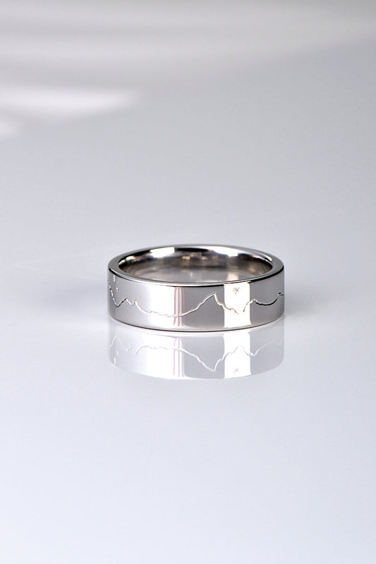 different and special wedding ring design hand engraved with a mountain range and a moon and stars
