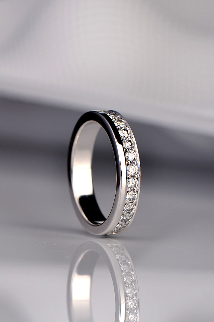 modern diamond set wedding ring for a woman that has the diamonds along one edge or the ring rather than in the middle from Christine Sadler