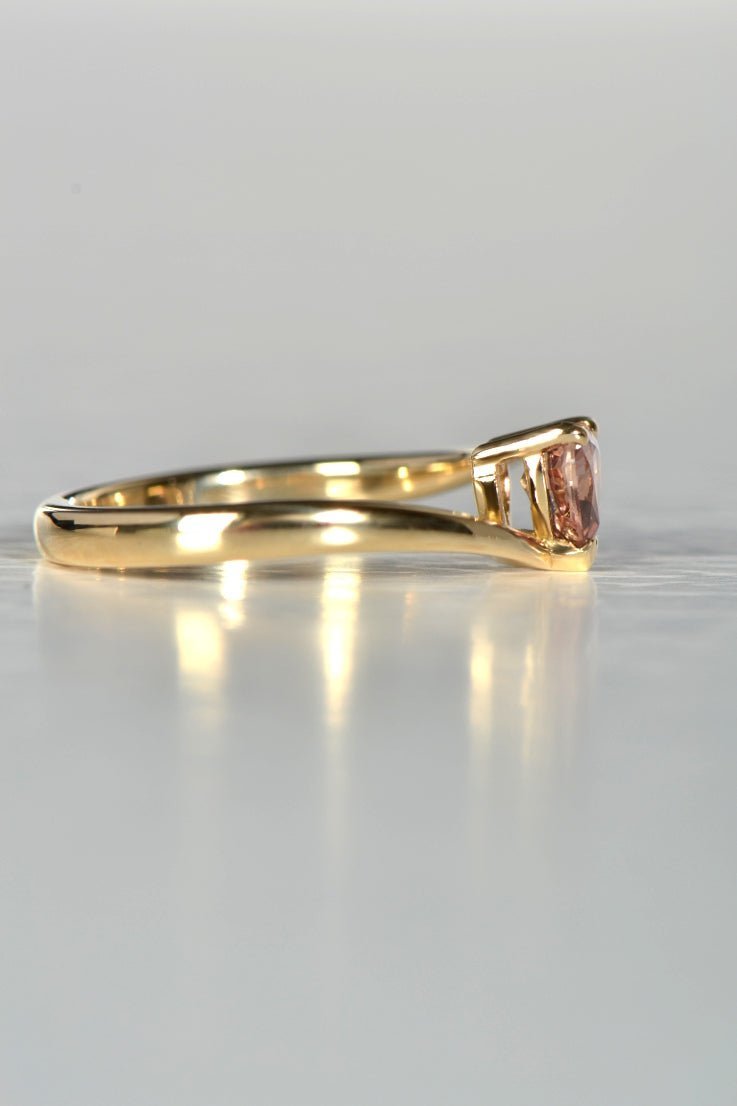 side view of modern ponk sapphire heart cut gold ring that has a twist - Christine Sadler