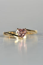 delicate gold ring set with a warm pink heart cut sapphire - Christine Sadler