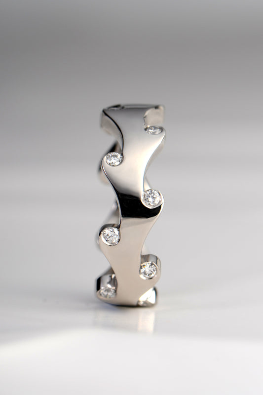 Contemporary designer platinum ring with diamonds that is different by Christine Sadler that can be worn by a man or woman as a wedding or eternity ring or a right hand ring.