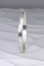 hundreds and thousands or sprinkles handmade silver bangle set with coloured sapphires and a diamond from Christine Sadler's afternoon tea jewellery collection