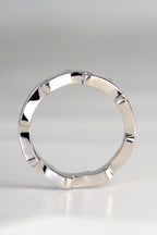 Side profile view of a unique sculptural platinum diamond wedding ring by Christine Sadler