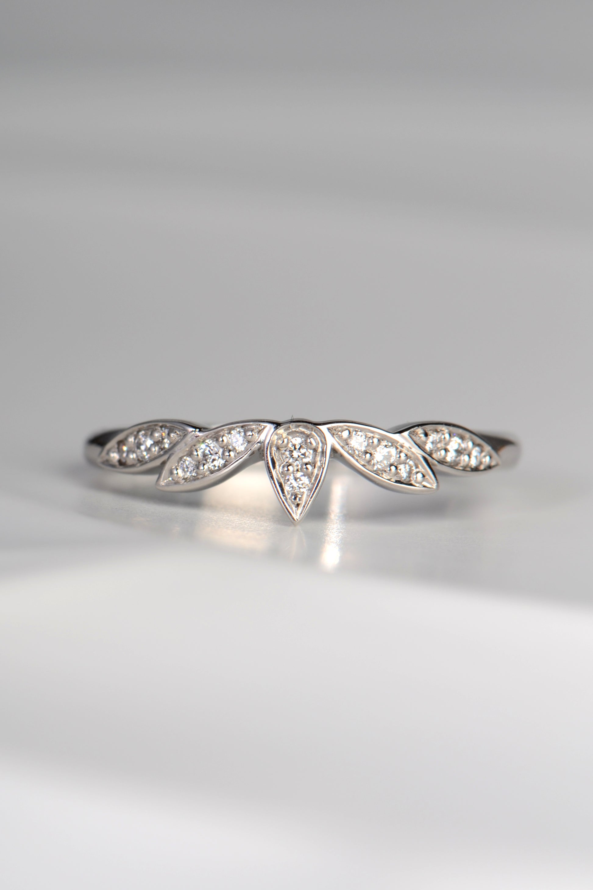 delicate diamond set platinum wedding ring with petal floral design, made in the UK