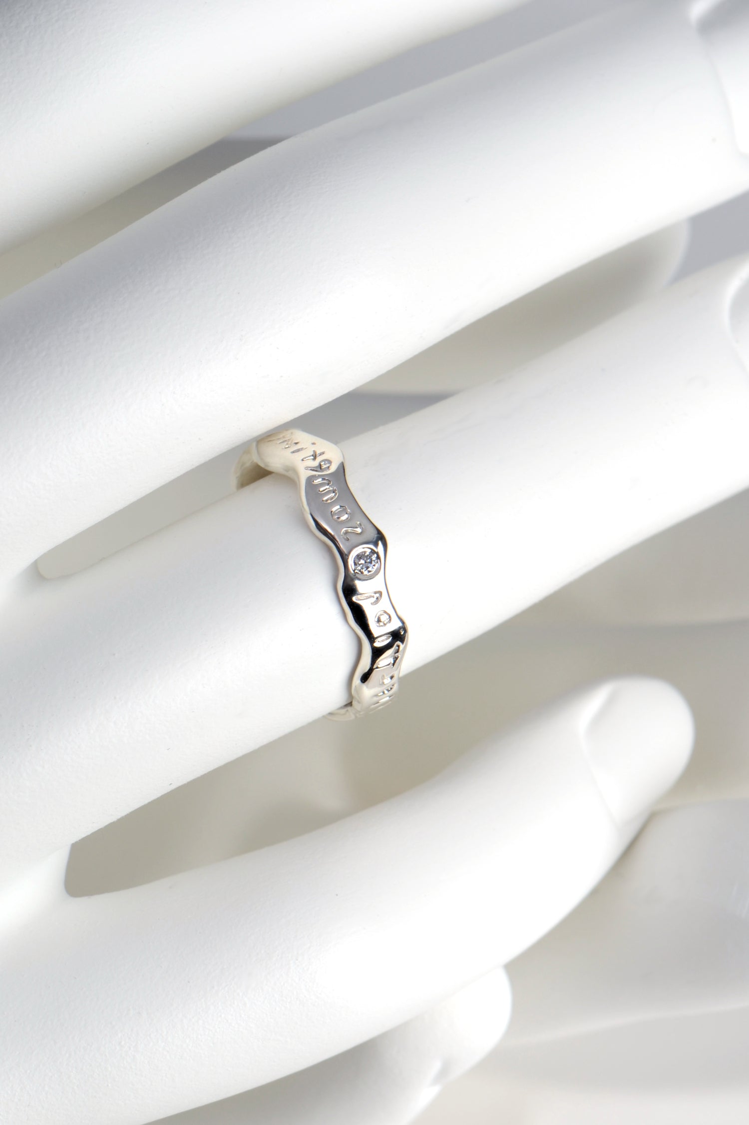 cool silver ring with engraving that you can read in the mirror  that shows a hidden message set with a diamond by Christine Sadler