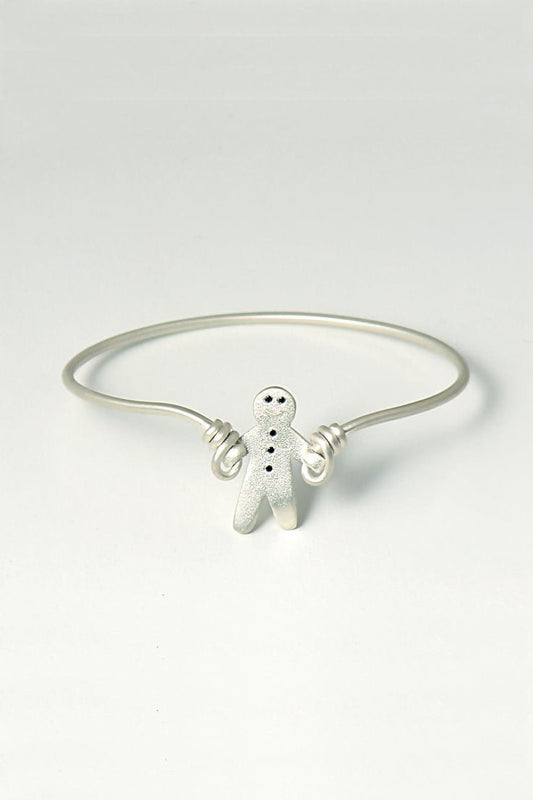 handmade silver bangle that is a gingerbread man set with black diamonds skipping with silver wire. British jewellery designer Christine Sadler