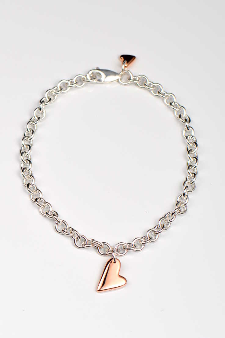 Sterling silver bracelet with two highly polished 9ct rose gold hearts — large front heart and small heart by secure lobster clasp, From The Heart collection