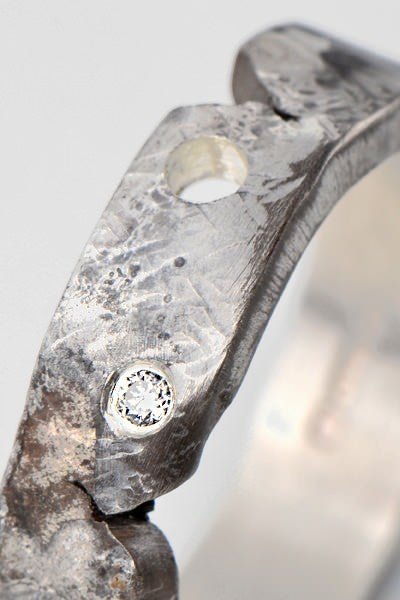 unique diamond ring for a man or woman that is oxidised and textured to look like it has sustained damage. Part of British jewellery designer Christine Sadler's Hero collection