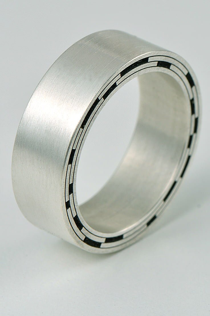 contemporary designer silver ring cut by engineering tools to a design inspired by star trails from British jewellery designer Christine Sadler