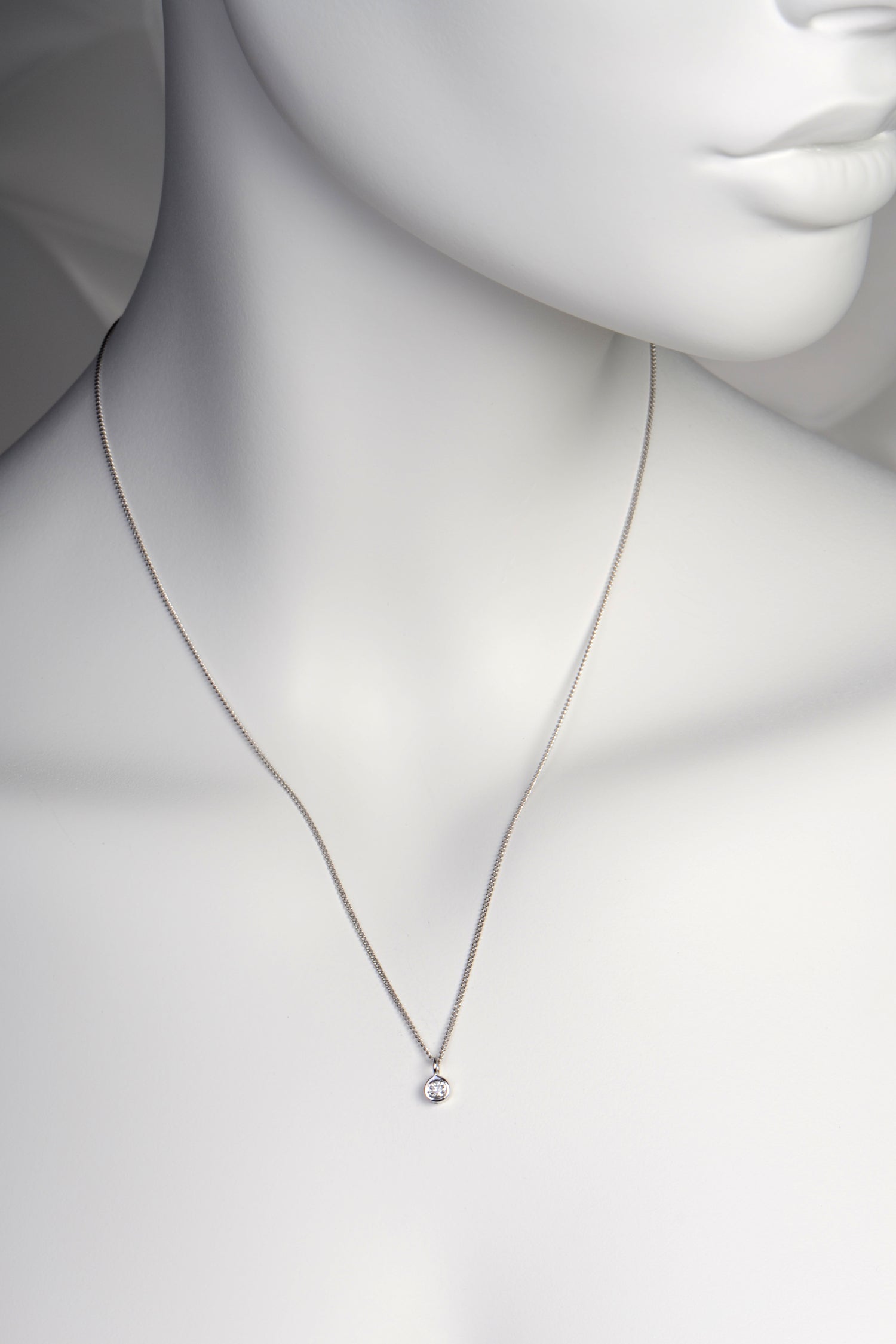 delicate lab diamond 9ct white gold necklace on white mannequin to show size and scale - Christine Sadler
