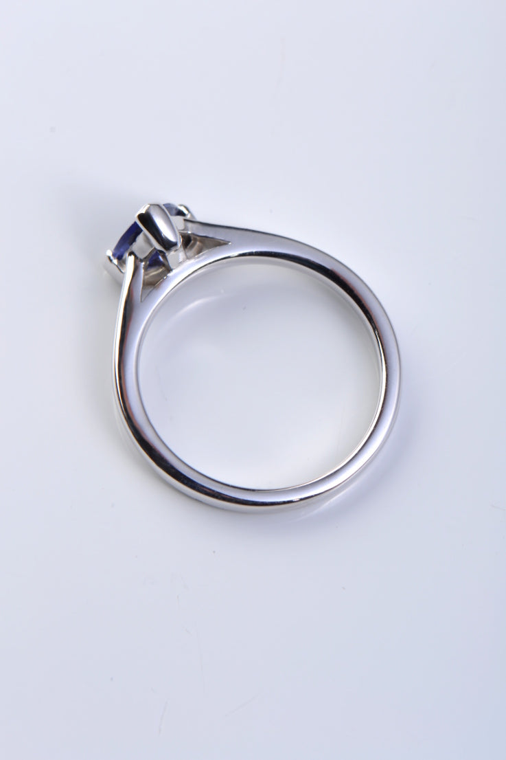 unique designer engagement ring design set with a triangle shaped tanzanite with diamonds in the band