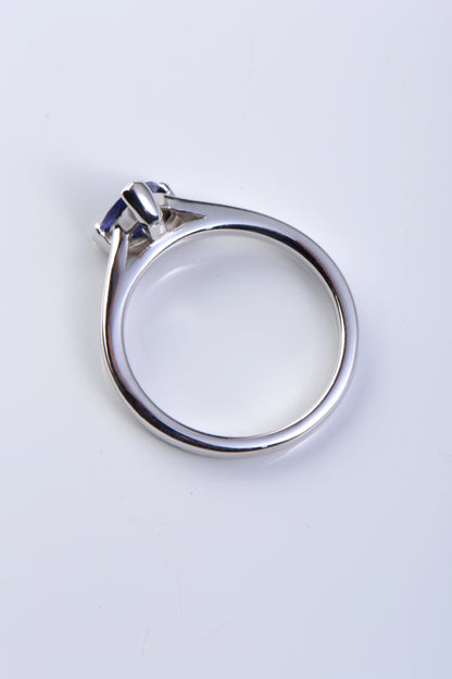 unique designer engagement ring design set with a triangle shaped tanzanite with diamonds in the band