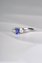 oval cut tanzanite ring with two round diamonds. This platinum engagement ring is handmade in the UK