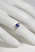 elegant tanzanite and diamond three stone ring shown worn on a finger
