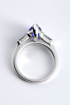 side view of 18ct white gold Pear Shaped Tanzanite & Diamond Engagement Ring on white background showing the pointed side