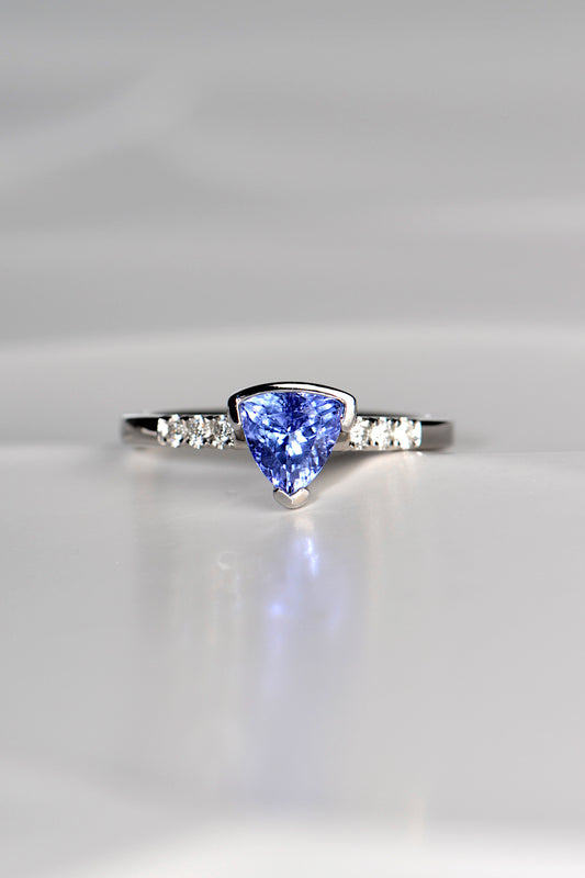 trillion cut tanzanite ring with three diamonds on either side exclusively available from fine jewellery designer Christine Sadler