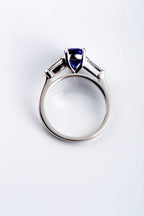 18ct white gold handcrafted Pear Shaped Tanzanite & Diamond Engagement Ring side view on white background showing the curved side