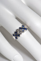 The tartan ring is set with a central 0.53ct princess cut diamond above a chequered pattern of 2mm blue sapphires . The platinum ring is 7.7mm wide at the front so it is a substantial statement engagement ring. This unusual Scottish diamond ring is unmistakably scottish. 