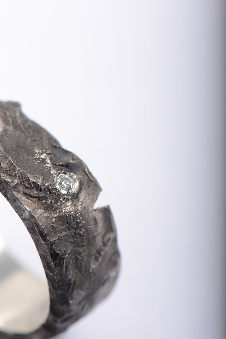 Close-up of Hero Ring by Christine Sadler showing textured oxidised silver and white diamond