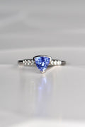 trillion cut tanzanite ring with three diamonds on either side exclusively available from fine jewellery designer Christine Sadler