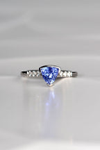 trillion cut tanzanite ring with three diamonds on either side exclusively available from fine jewellery designer Christine Sadler