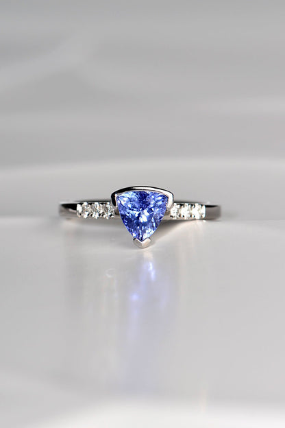 trillion cut tanzanite ring with three diamonds on either side exclusively available from fine jewellery designer Christine Sadler