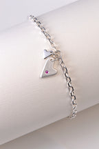 handmade silver bracelet for a woman or a girl with two hearts, one of which is set with a pink sapphire